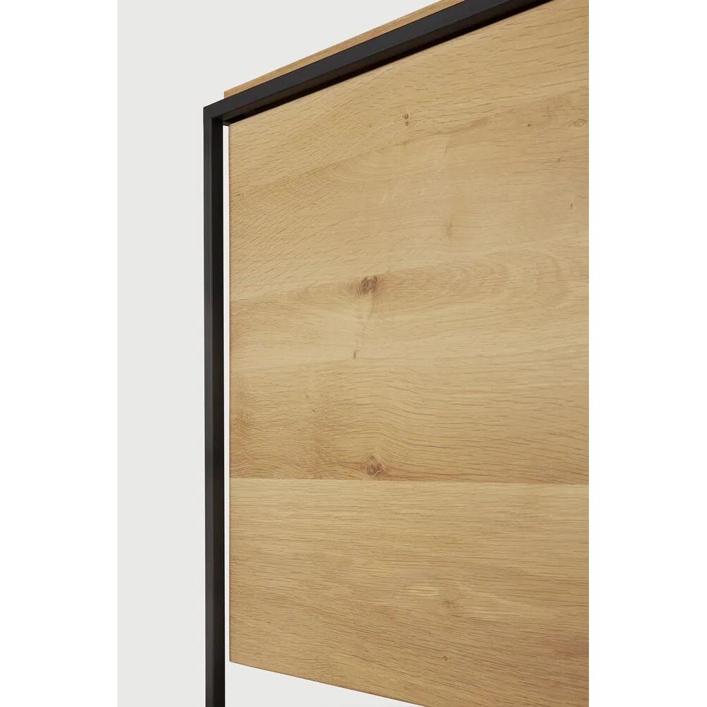 Featuring Monolit Sideboard by Ethnicraft at Amethyst Home. Practicality without sacrificing style. The contrasting characteristics of wood and the rectangular metal frame of the Monolit sideboard create a unique backdrop for all modern media equipment.
Dimensions: 20.5" L x 46" W x 33" H 
Adjustable Shelves : YesAnti-tipping mechanism : YesBrushed : This fini. Amethyst Home provides interior design, new home construction design consulting, vintage area rugs, and lighting in the Boston metro area.