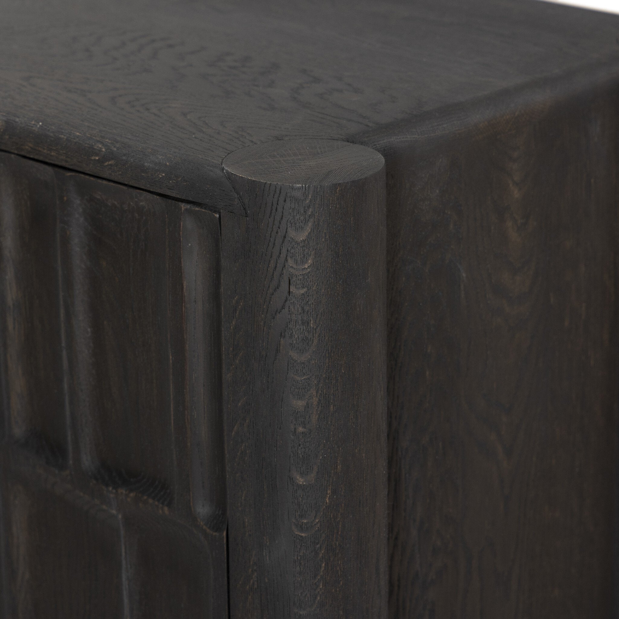 Featuring Ezri Black Oak Sideboard by Four Hands at Amethyst Home. Grain and character variation within a solid oak finish give this sideboard organic visual interest. The carved design and floor-to-top cylinder legs give a primitive look that balances the movement of the wood pattern.Overall Dimensions: 98.00"w x 18.00"d x 34.00"hWeight : 245.38 lbsMaterials : Solid Oak. Amethyst Home provides interior design, new construction, custom furniture, and area rugs in the Miami metro area