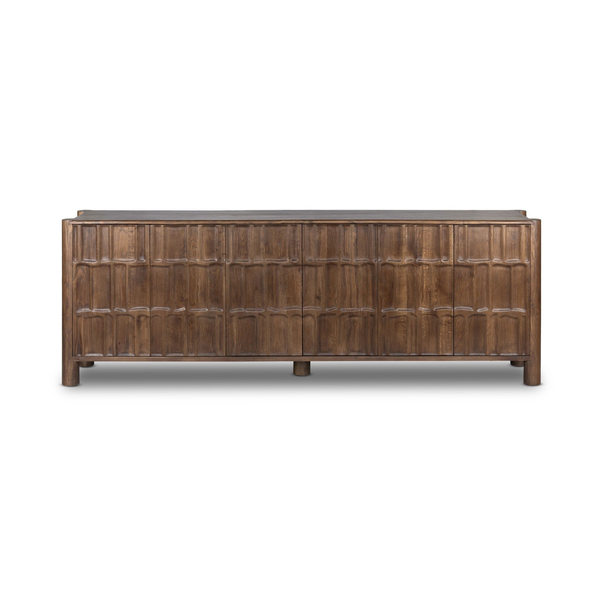 Featuring Ezri Cocoa Oak Sideboard by Four Hands at Amethyst Home. Grain and character variation within a solid oak finish give this sideboard organic visual interest. The carved design and floor-to-top cylinder legs give a primitive look that balances the movement of the wood pattern.Overall Dimensions: 98.00"w x 18.00"d x 34.00"hWeight : 245.38 lbsMaterials : Solid Oak. Amethyst Home provides interior design, new construction, custom furniture, and area rugs in the Los Angeles metro area