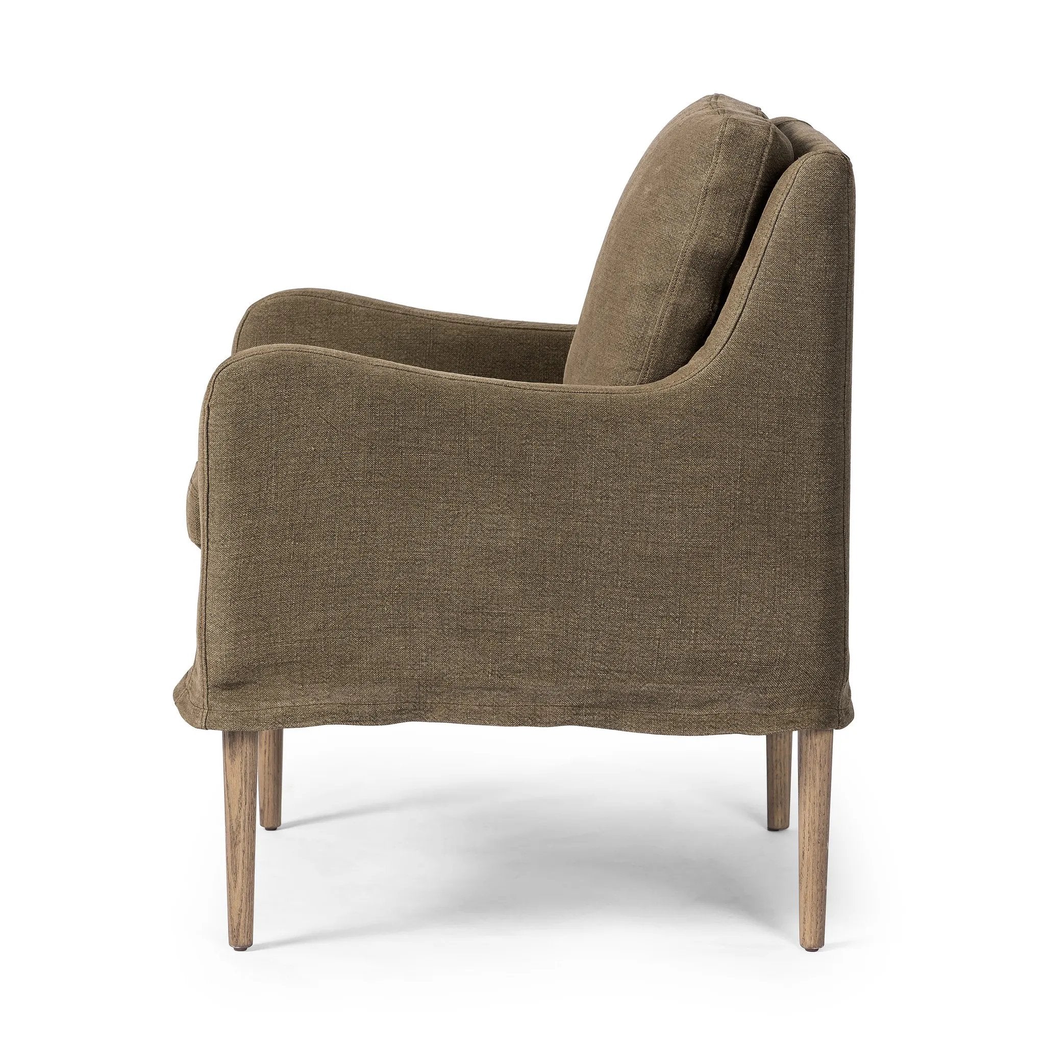 Heritage-inspired comfort. Sloping track arms are a study in playful forms, while the frame's fluid shape creates a simple, polished look. Tapered legs extend beyond a short skirt for a more relaxed style. Covered in 100% linen. A design collaboration by Amber Lewis and Four Hands. Amethyst Home provides interior design, new home construction design consulting, vintage area rugs, and lighting in the Alpharetta metro area.