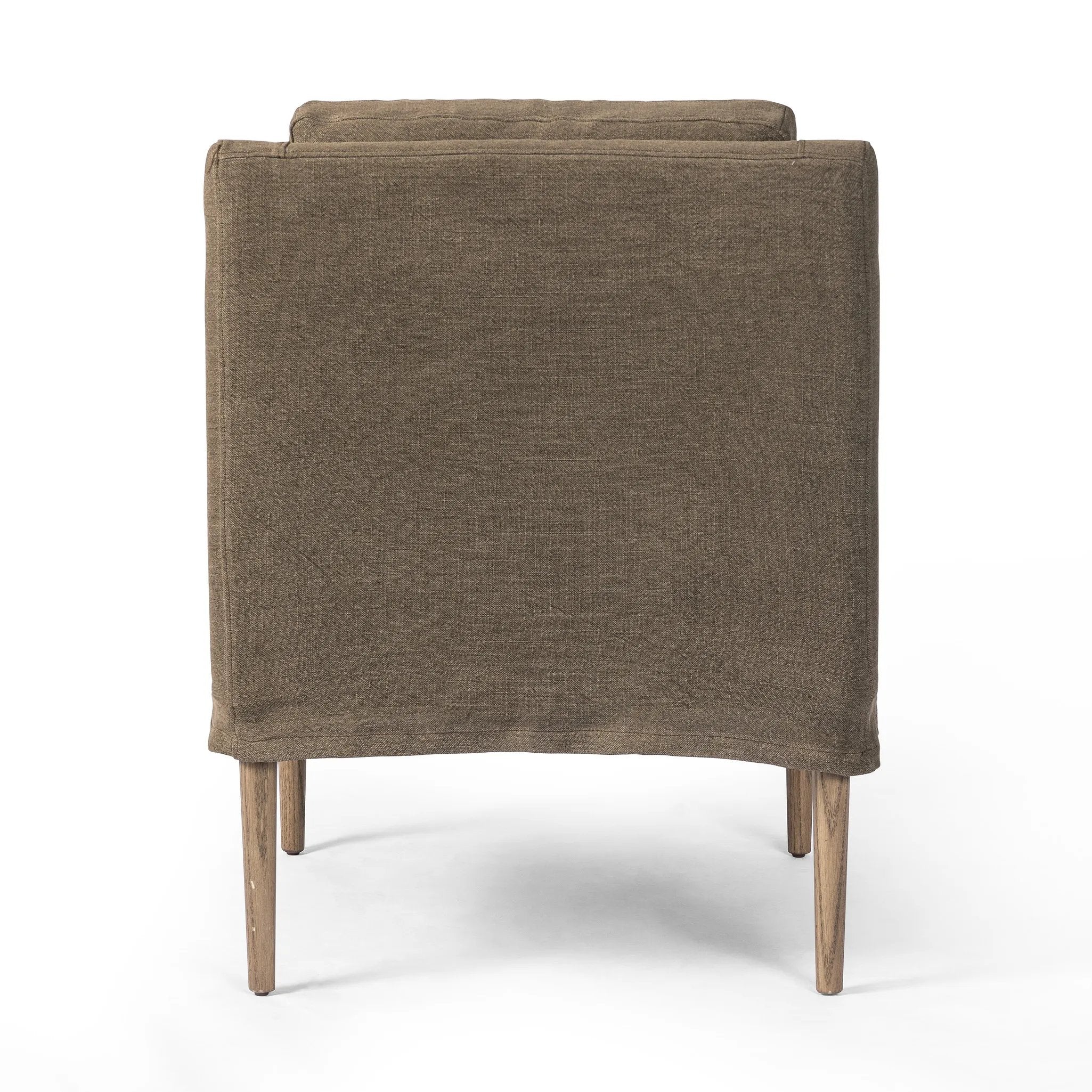 Heritage-inspired comfort. Sloping track arms are a study in playful forms, while the frame's fluid shape creates a simple, polished look. Tapered legs extend beyond a short skirt for a more relaxed style. Covered in 100% linen. A design collaboration by Amber Lewis and Four Hands. Amethyst Home provides interior design, new home construction design consulting, vintage area rugs, and lighting in the Newport Beach metro area.