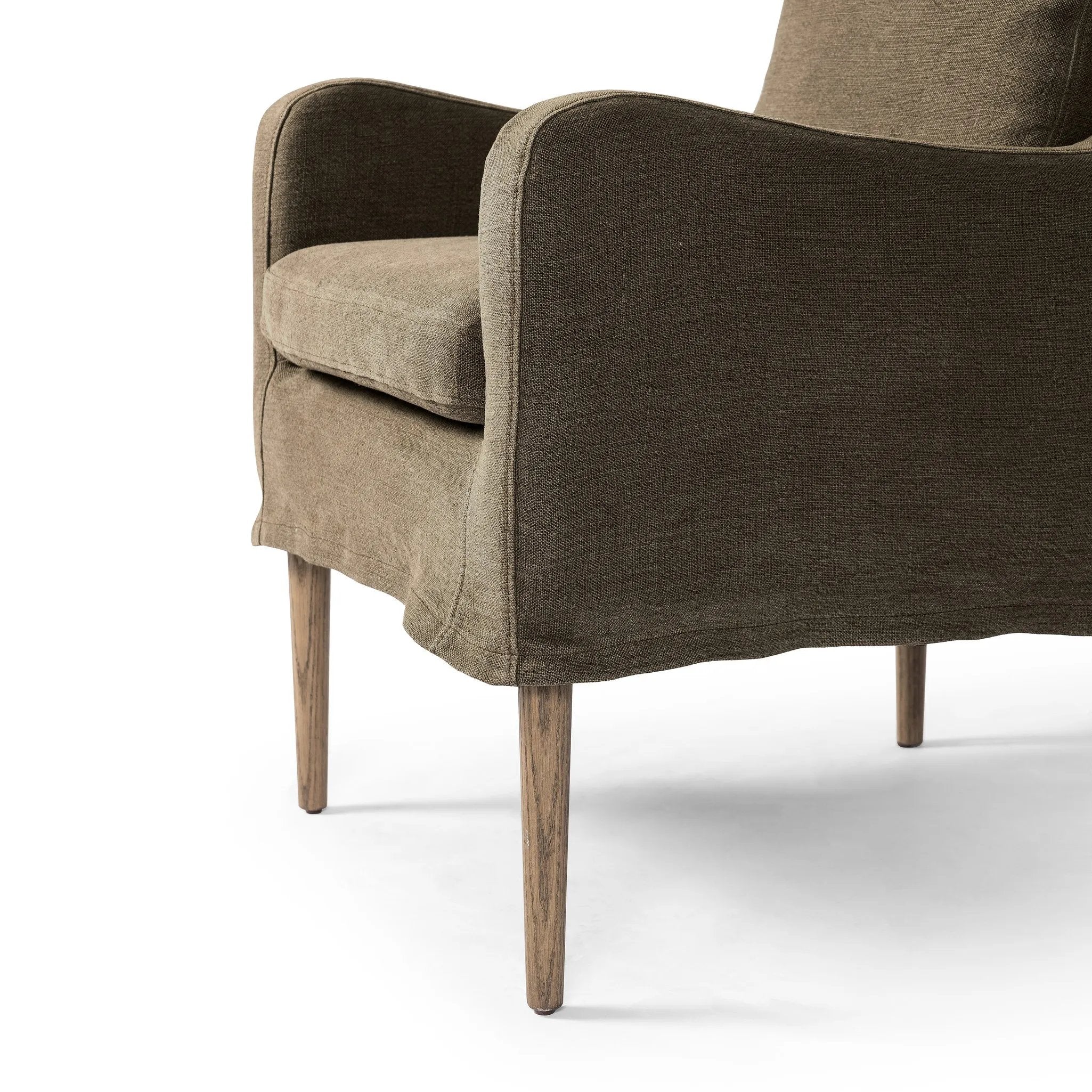 Heritage-inspired comfort. Sloping track arms are a study in playful forms, while the frame's fluid shape creates a simple, polished look. Tapered legs extend beyond a short skirt for a more relaxed style. Covered in 100% linen. A design collaboration by Amber Lewis and Four Hands. Amethyst Home provides interior design, new home construction design consulting, vintage area rugs, and lighting in the Portland metro area.