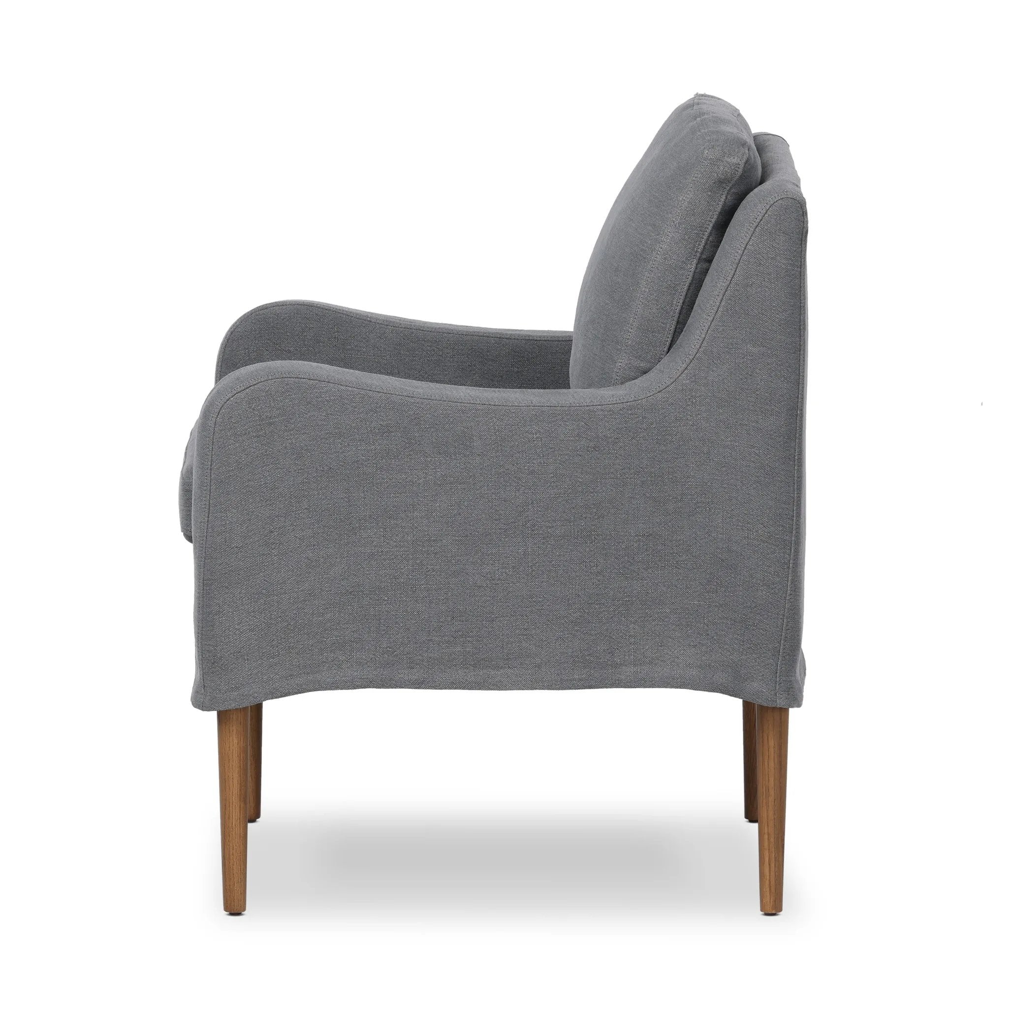 Heritage-inspired comfort. Sloping track arms are a study in playful forms, while the frame's fluid shape creates a simple, polished look. Tapered legs extend beyond a short skirt for a more relaxed style. Covered in 100% linen. A design collaboration by Amber Lewis and Four Hands. Amethyst Home provides interior design, new home construction design consulting, vintage area rugs, and lighting in the Scottsdale metro area.