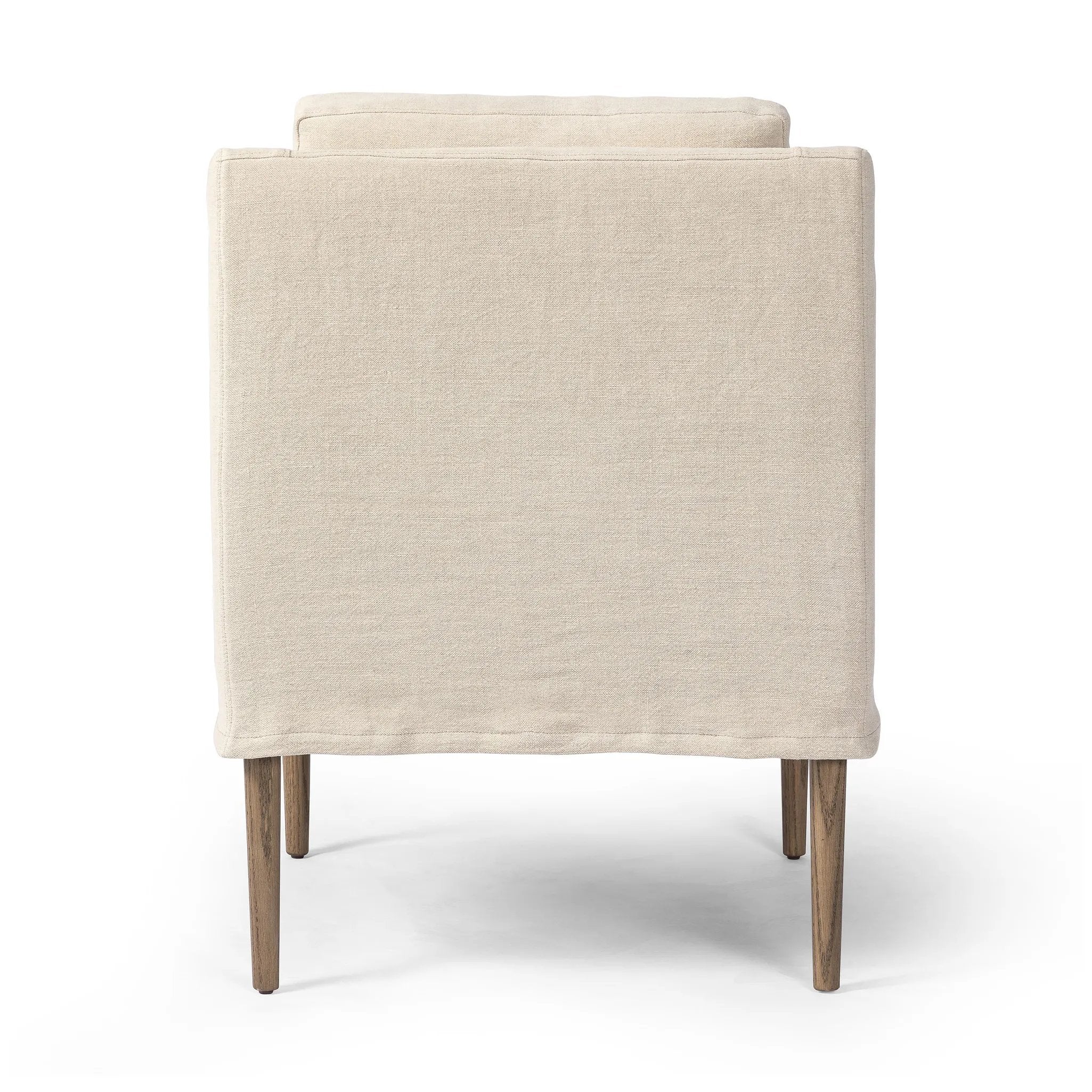 Heritage-inspired comfort. Sloping track arms are a study in playful forms, while the frame's fluid shape creates a simple, polished look. Tapered legs extend beyond a short skirt for a more relaxed style. Covered in 100% linen. A design collaboration by Amber Lewis and Four Hands. Amethyst Home provides interior design, new home construction design consulting, vintage area rugs, and lighting in the Alpharetta metro area.