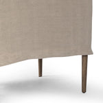 Heritage-inspired comfort. Sloping track arms are a study in playful forms, while the frame's fluid shape creates a simple, polished look. Tapered legs extend beyond a short skirt for a more relaxed style. Covered in 100% linen. A design collaboration by Amber Lewis and Four Hands. Amethyst Home provides interior design, new home construction design consulting, vintage area rugs, and lighting in the Houston metro area.