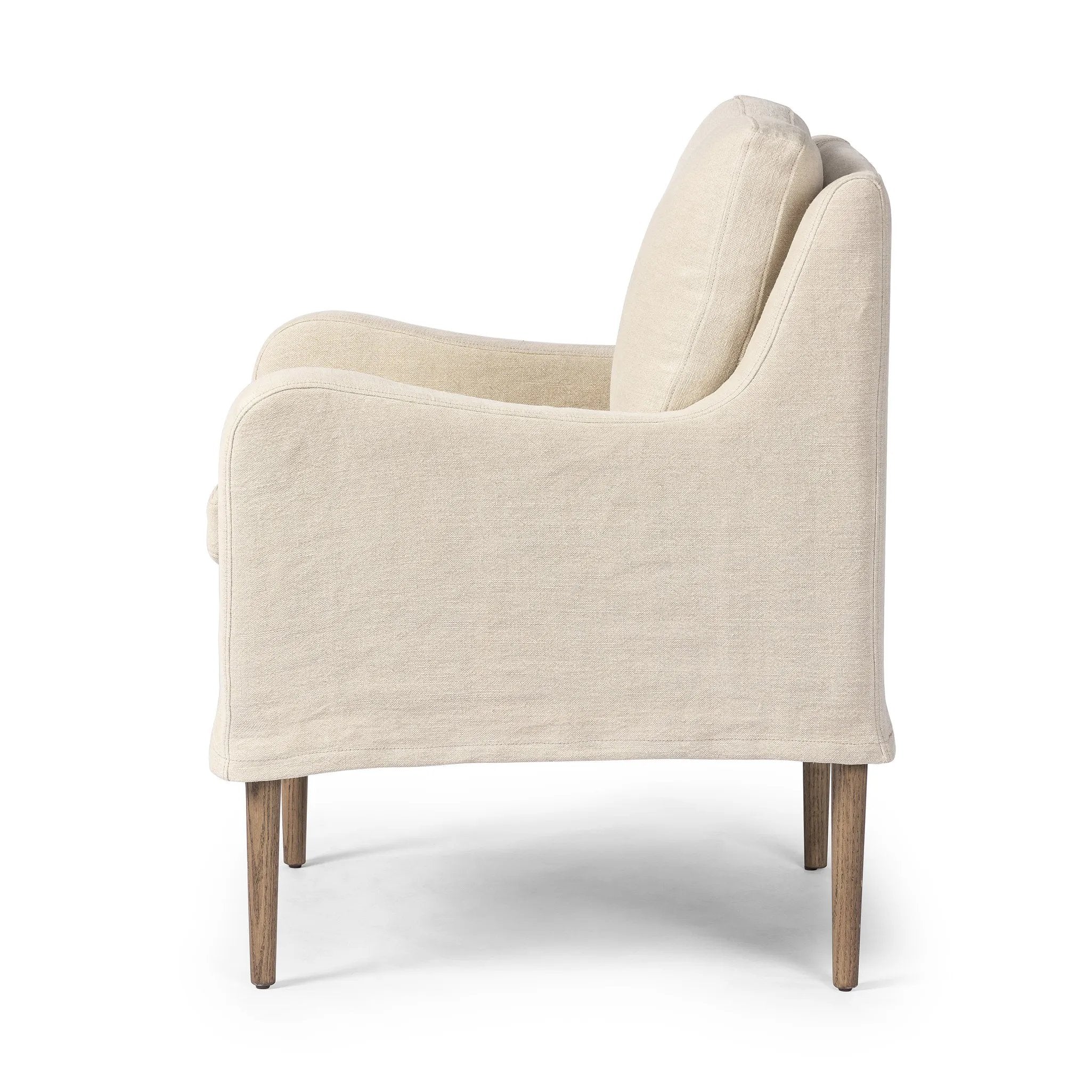 Heritage-inspired comfort. Sloping track arms are a study in playful forms, while the frame's fluid shape creates a simple, polished look. Tapered legs extend beyond a short skirt for a more relaxed style. Covered in 100% linen. A design collaboration by Amber Lewis and Four Hands. Amethyst Home provides interior design, new home construction design consulting, vintage area rugs, and lighting in the Nashville metro area.