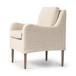 Heritage-inspired comfort. Sloping track arms are a study in playful forms, while the frame's fluid shape creates a simple, polished look. Tapered legs extend beyond a short skirt for a more relaxed style. Covered in 100% linen. A design collaboration by Amber Lewis and Four Hands. Amethyst Home provides interior design, new home construction design consulting, vintage area rugs, and lighting in the Portland metro area.