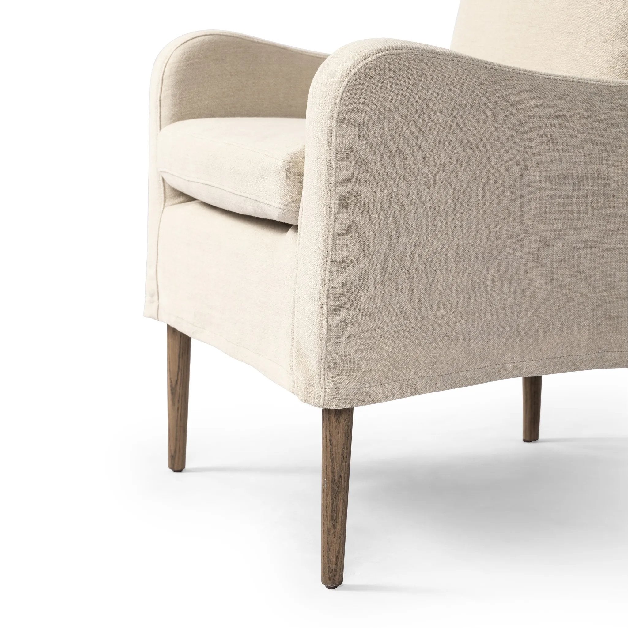 Heritage-inspired comfort. Sloping track arms are a study in playful forms, while the frame's fluid shape creates a simple, polished look. Tapered legs extend beyond a short skirt for a more relaxed style. Covered in 100% linen. A design collaboration by Amber Lewis and Four Hands. Amethyst Home provides interior design, new home construction design consulting, vintage area rugs, and lighting in the Salt Lake City metro area.