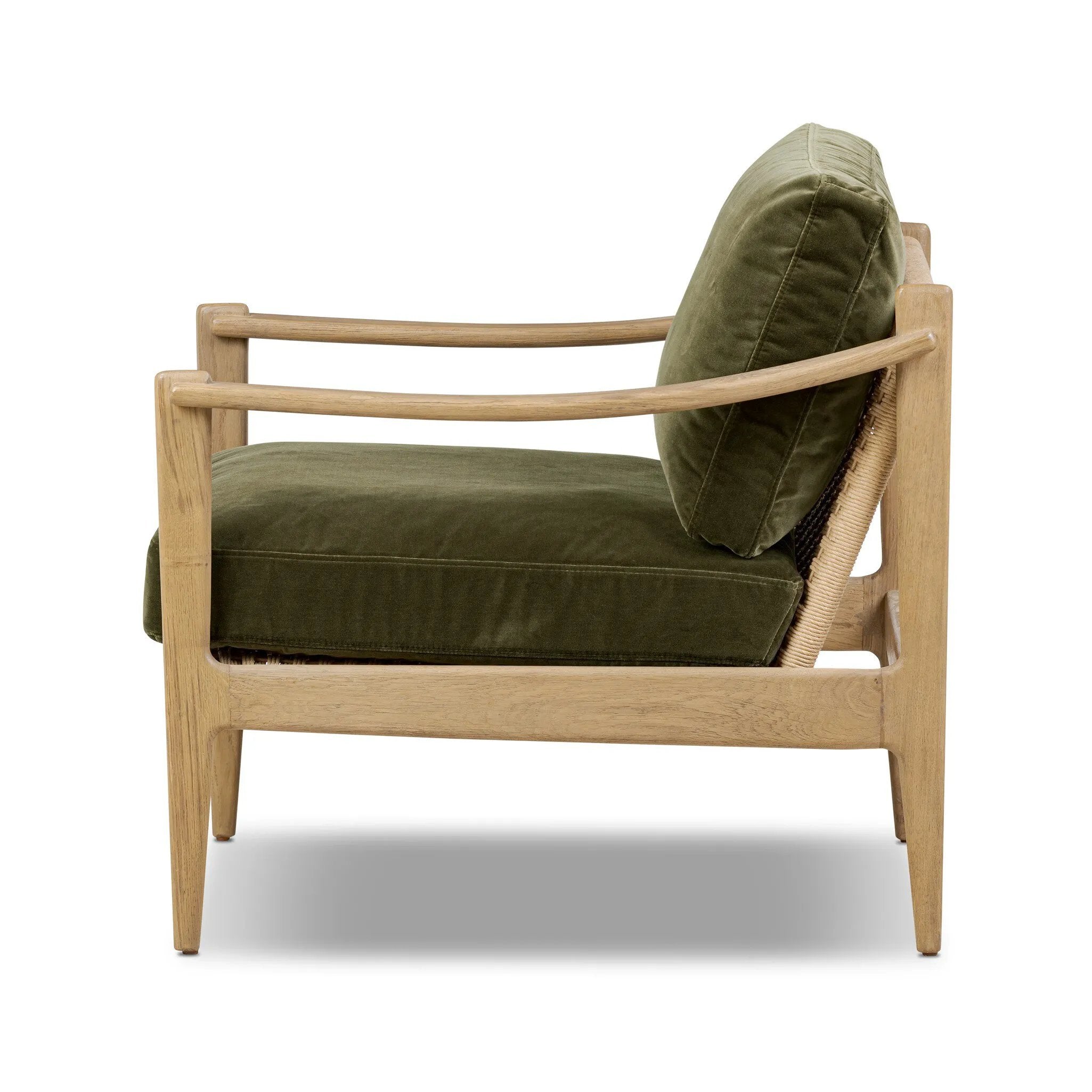 Tapered legs and sloped paddle arms frame the visible joinery and handwoven rope details of this accent chair, for a monochromatic yet visually intriguing frame. Finished with loose, velvet-upholstered seat and back cushions in a rich olive hue — for a subtle color contrast that celebrates the natural beauty of each material Amethyst Home provides interior design, new home construction design consulting, vintage area rugs, and lighting in the Los Angeles metro area.