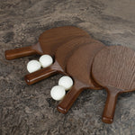 Fun meets flexibility. Two large slabs of warm grey marble, framed in rich oak, join together and sit atop the minimalist plinth bases of this dual-purpose ping pong table. The wooden "net" fastens to the table with custom gunmetal clamps, which can be easily removed for a dining table that seats 12 Amethyst Home provides interior design, new home construction design consulting, vintage area rugs, and lighting in the Newport Beach metro area.