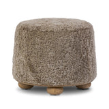 For an extra seat or propped feet, this welcoming ottoman features a subtly tapered shape and a rounded base with bun feet beneath. Crafted from solid oak and upholstered with taupe shearling for extra texture Amethyst Home provides interior design, new home construction design consulting, vintage area rugs, and lighting in the Houston metro area.