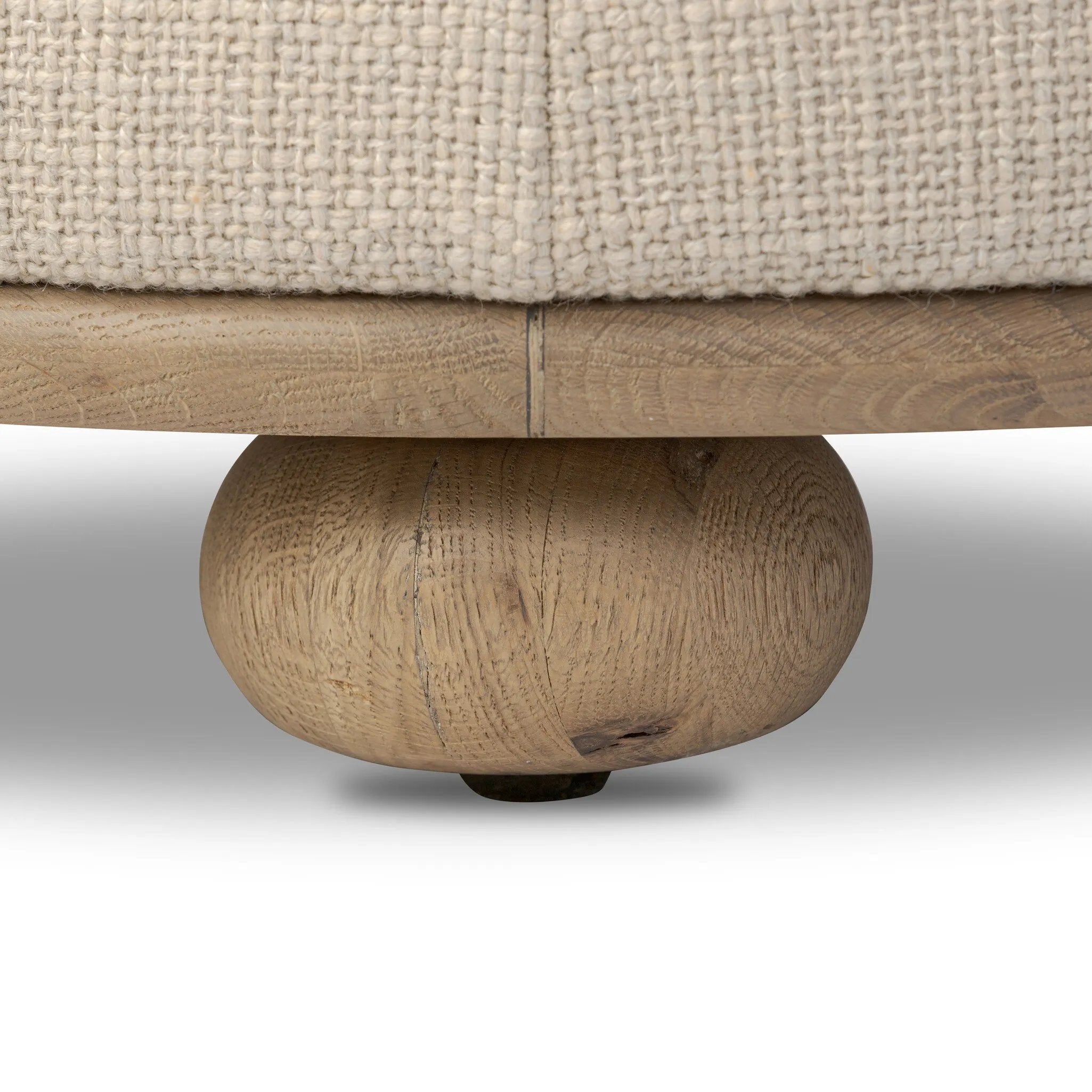 Featuring Bilbury Saxon Sand Ottoman by Four Hands at Amethyst Home. For an extra seat or propped feet, this welcoming ottoman features a subtly tapered shape and a rounded base with oak bun feet beneath. Crafted with soft foam cushioning and upholstered in a poly/wool blend fabric. Overall Dimensions: 22.00"w x 22.00"d x 18.50"h. Amethyst Home provides interior design, new home construction design consulting, vintage area rugs, and lighting in the Calabasas metro area.