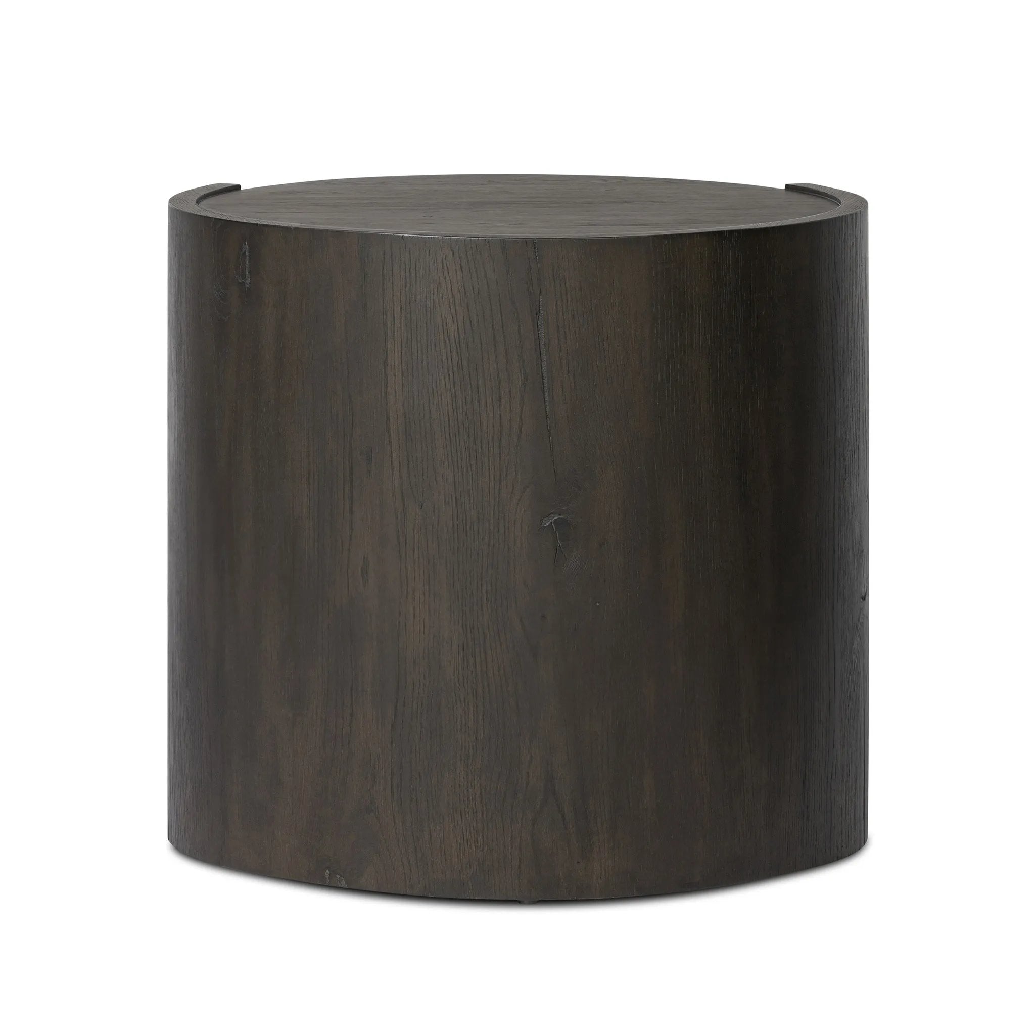 Rich contours bring character to the bedside. A round black-finished oak table has a spacious cubby and a single drawer with metal glides and a bronzed pull Amethyst Home provides interior design, new home construction design consulting, vintage area rugs, and lighting in the Austin metro area.