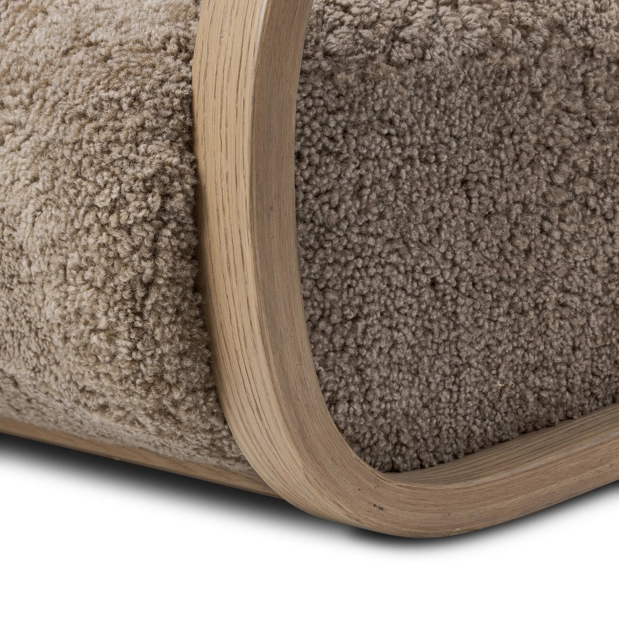 Soft texture and eye-catching contours fuse in this comfort-driven accent chair, pairing a low, luxurious shearling seat and