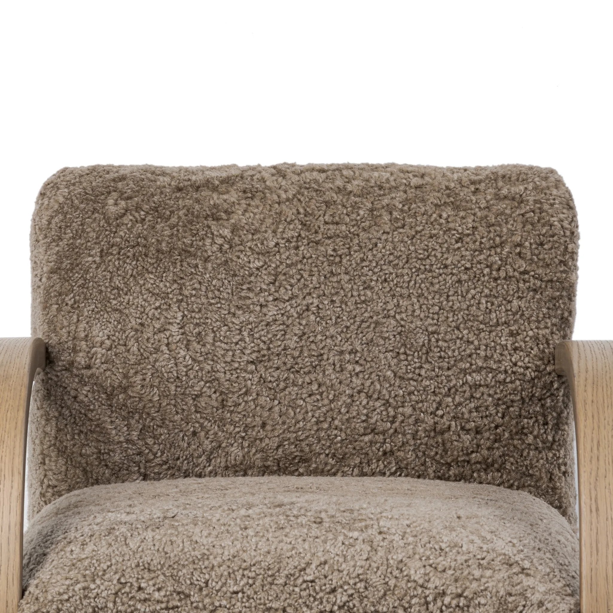 Soft texture and eye-catching contours fuse in this comfort-driven accent chair, pairing a low, luxurious shearling seat and
