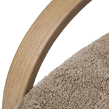 Soft texture and eye-catching contours fuse in this comfort-driven accent chair, pairing a low, luxurious shearling seat and