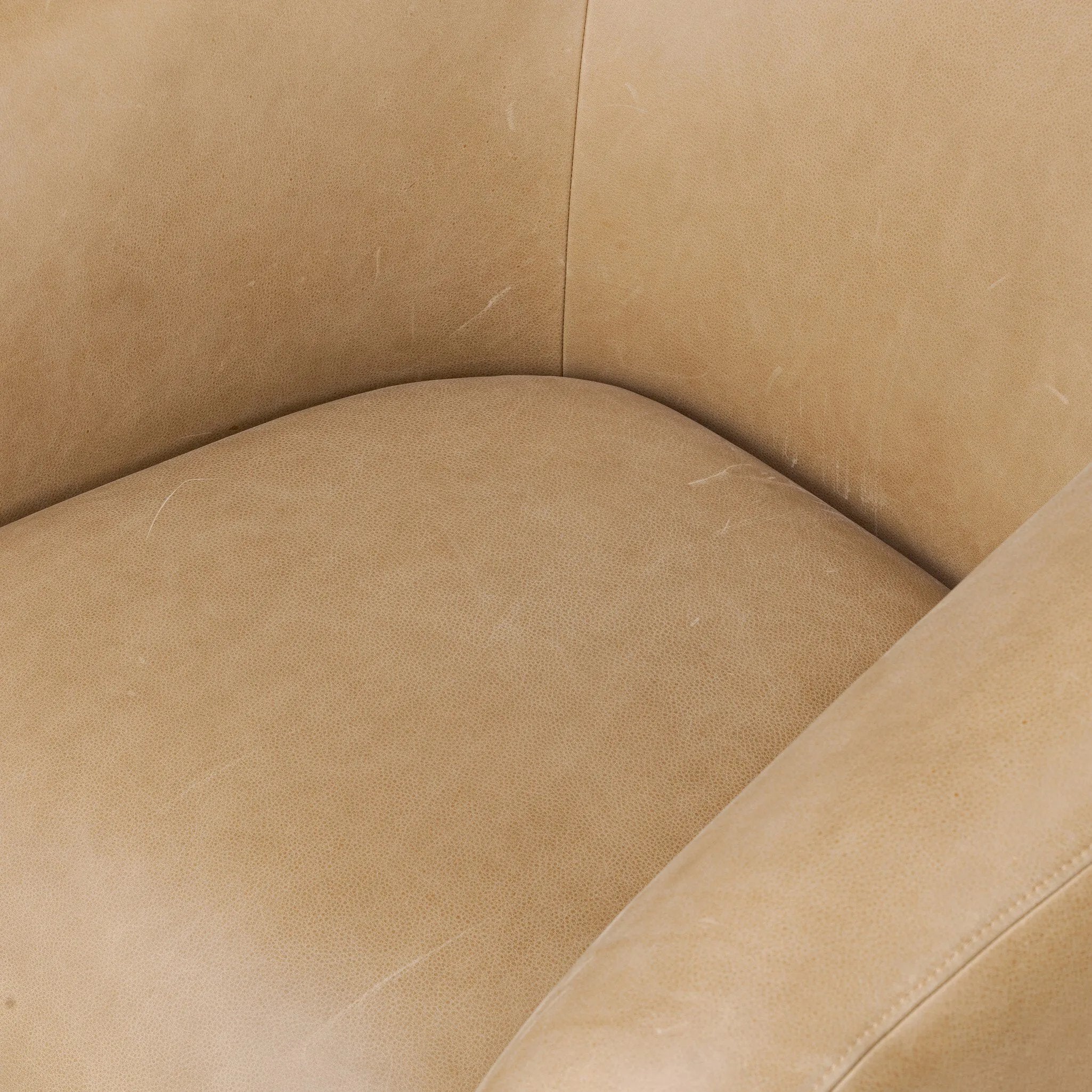 Meet modern comfort. Clean curves, impeccable tailoring and taupe top-grain leather with a pronounced grain bring an elevated, European-inspired look to this swivel chair Amethyst Home provides interior design, new home construction design consulting, vintage area rugs, and lighting in the Washington metro area.