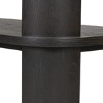 Unexpected contours give this bookcase its warm, modern vibe. Crafted oak veneer with a worn black finish, rounded legs are inset from the shelves with a plinth-like effect Amethyst Home provides interior design, new home construction design consulting, vintage area rugs, and lighting in the Los Angeles metro area.