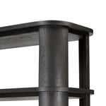 Unexpected contours give this bookcase its warm, modern vibe. Crafted oak veneer with a worn black finish, rounded legs are inset from the shelves with a plinth-like effect Amethyst Home provides interior design, new home construction design consulting, vintage area rugs, and lighting in the Seattle metro area.