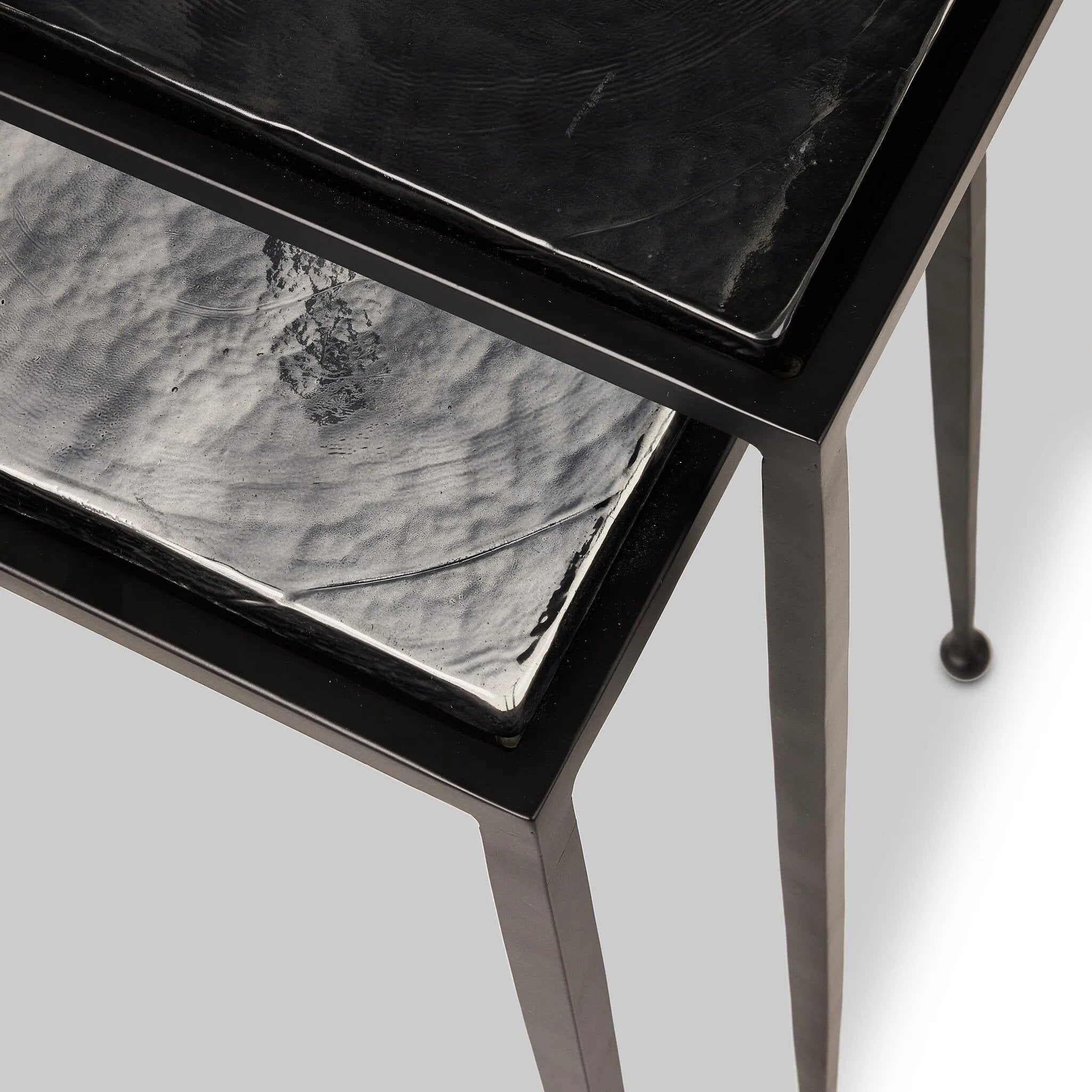 Featuring Dexter Smoked Black Cast Glass Nesting Tables by Four Hands at Amethyst Home. Embrace the mysterious with the Dexter smoked glass nesting tables.  Beautiful smoked glass gives a warm modern vibe while being practical.Overall Dimensions: 16.25"w x 16.25"d x 21.00"hWeight : 52.91 lbsMaterials : Cast Glass, Iron. Amethyst Home provides interior design, new home construction design consulting, vintage area rugs, and lighting in the Nashville metro area.