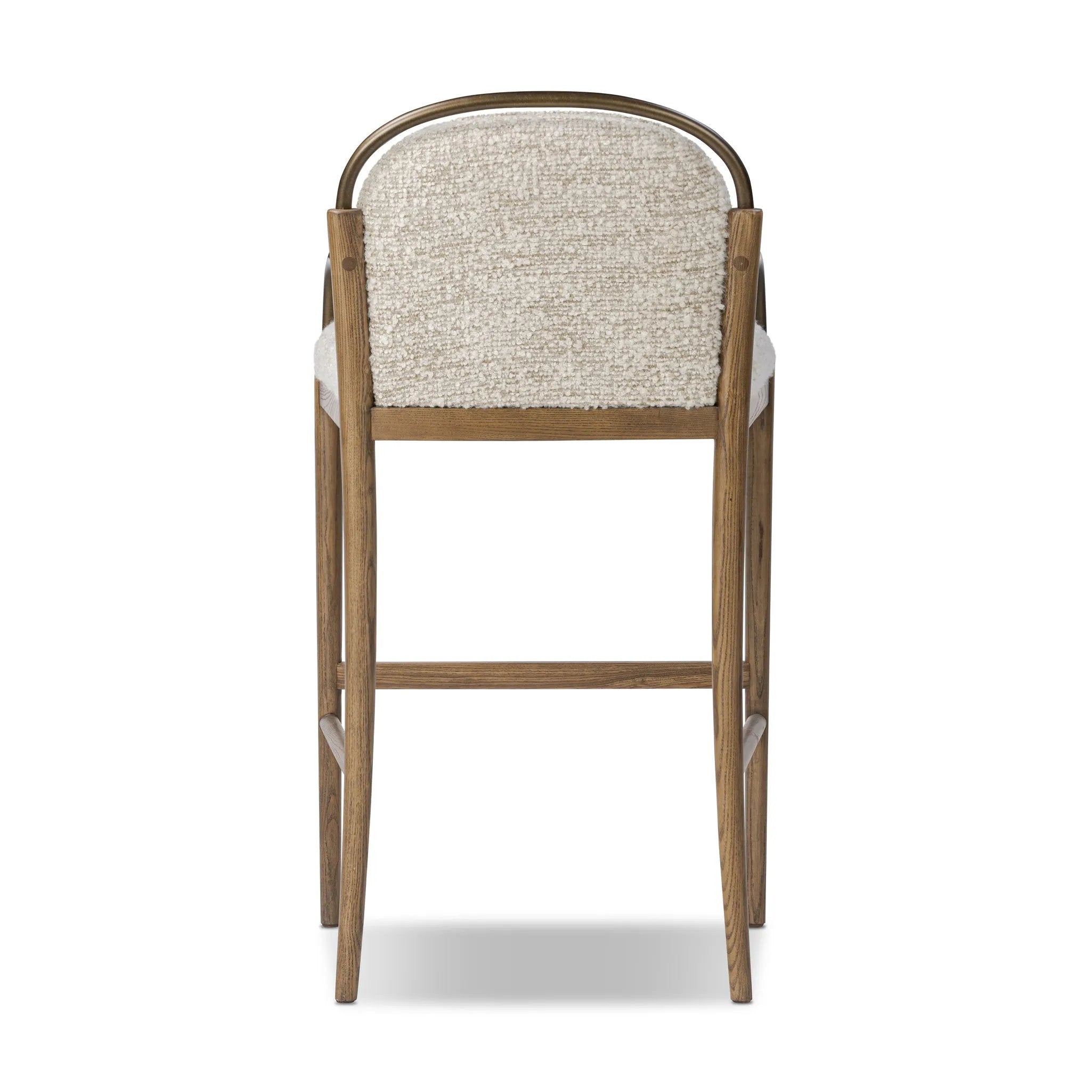 A tribute to traditional artistry and found pieces, this bar stool fluidly combines ash and burnished brass to frame a comfortable S-spring seat. Finished in heavy boucle-like upholstery that features a subtle linear pattern for added depth — creating a luxe, inviting feel. A design collaboration by Amber Lewis and Four Hands. Amethyst Home provides interior design, new home construction design consulting, vintage area rugs, and lighting in the Dallas metro area.