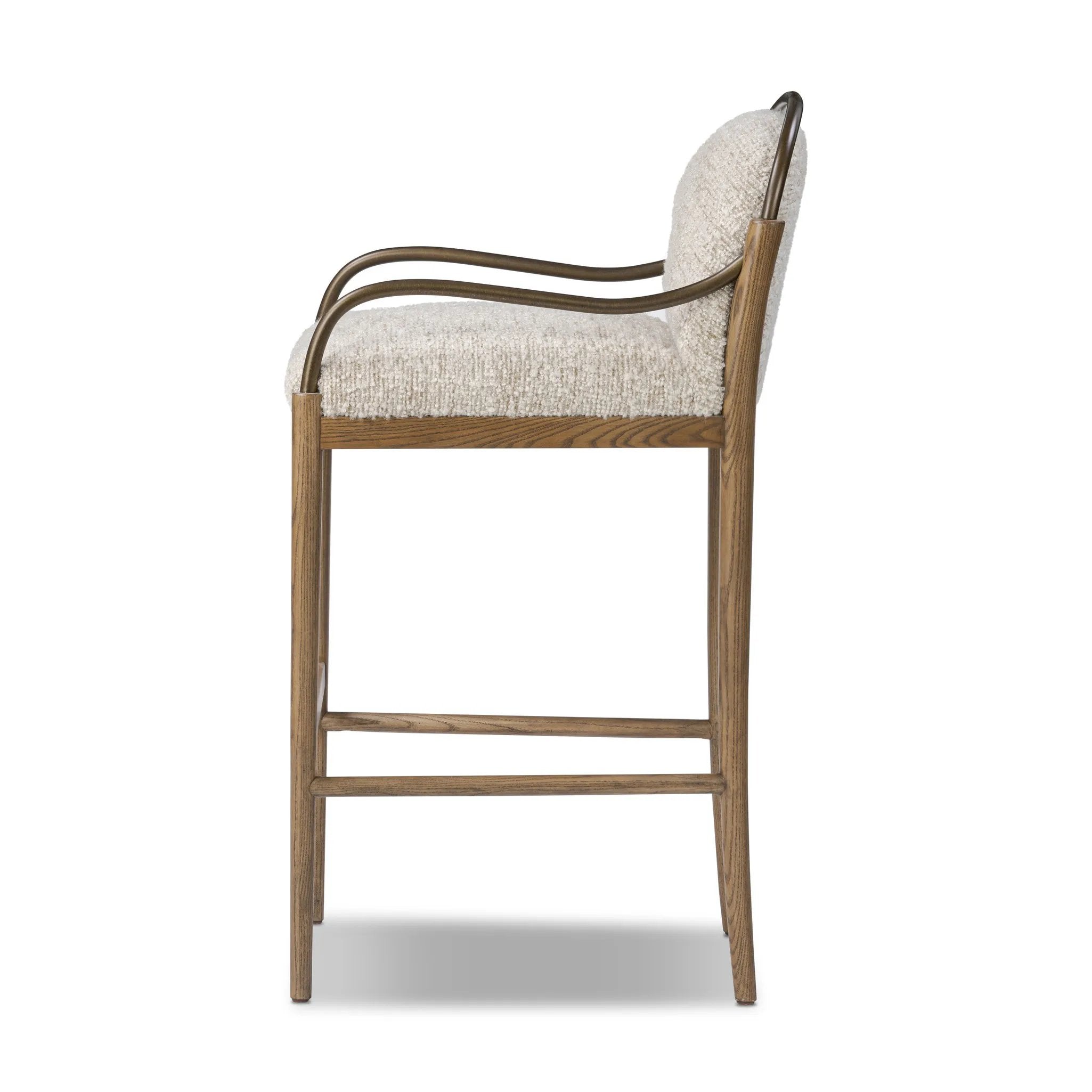 A tribute to traditional artistry and found pieces, this bar stool fluidly combines ash and burnished brass to frame a comfortable S-spring seat. Finished in heavy boucle-like upholstery that features a subtle linear pattern for added depth — creating a luxe, inviting feel. A design collaboration by Amber Lewis and Four Hands. Amethyst Home provides interior design, new home construction design consulting, vintage area rugs, and lighting in the Park City metro area.