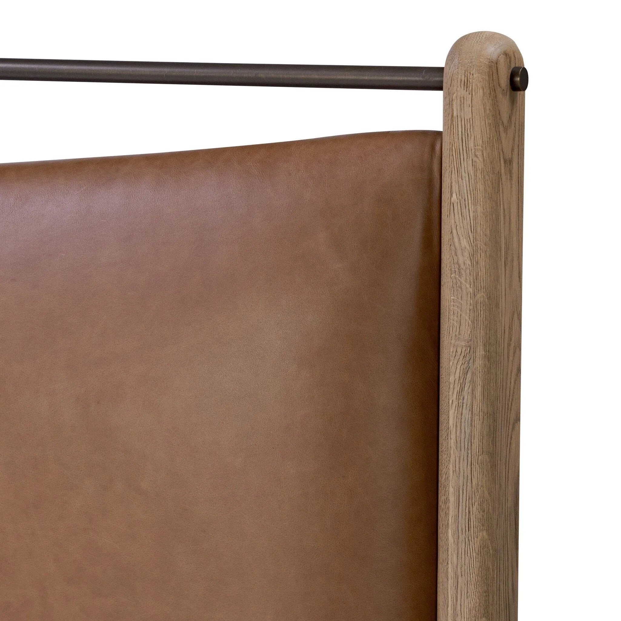 Slightly scooped top-grain leather tufting is bridged with metal bars in brushed brass for modern detailing. Aged smoked oak frames the three-paneled headboard and footboard wrapped in chestnut top-grain leather. Rounded legs soften the look Amethyst Home provides interior design, new home construction design consulting, vintage area rugs, and lighting in the Alpharetta metro area.