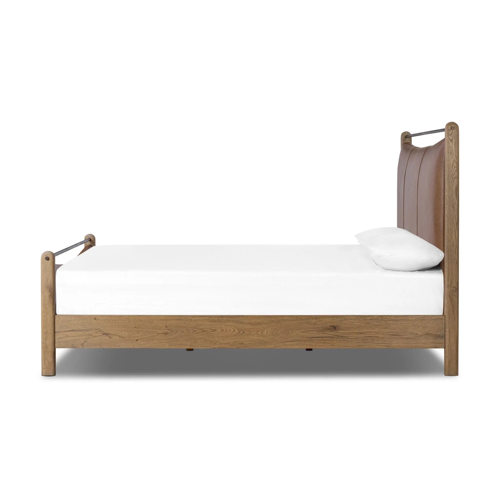 Slightly scooped top-grain leather tufting is bridged with metal bars in brushed brass for modern detailing. Aged smoked oak frames the three-paneled headboard and footboard wrapped in chestnut top-grain leather. Rounded legs soften the look Amethyst Home provides interior design, new home construction design consulting, vintage area rugs, and lighting in the Laguna Beach metro area.