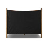 Slightly scooped top-grain leather tufting is bridged with metal bars in brushed brass for modern detailing. Aged smoked oak