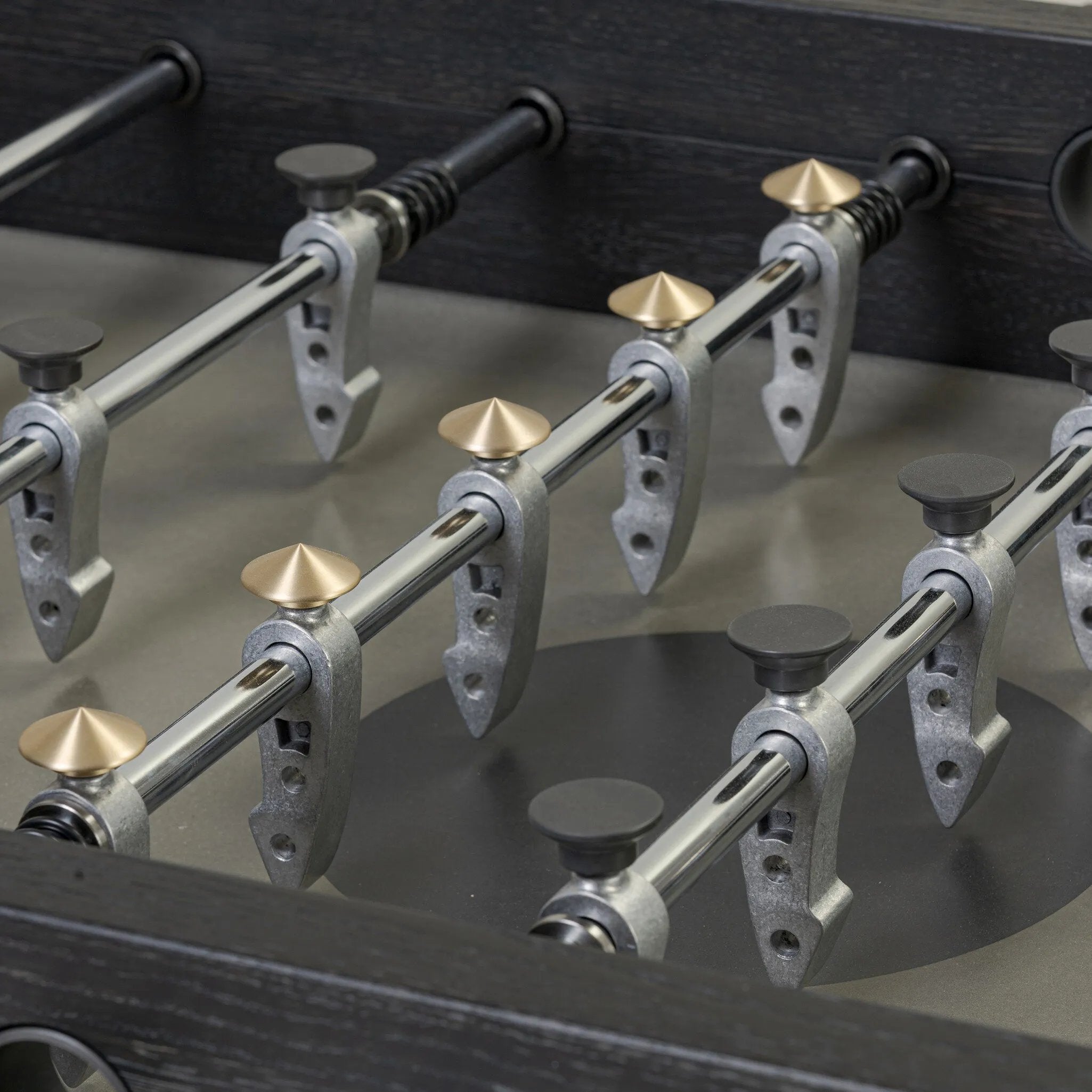 Streamlined for fun. This foosball table features a concrete playing surface and distinctly detailed players in cast aluminum. Rounded square wooden handles and cylindrical metal score counters tie together the sleek, industrial look of this foosball table, finished with tapered cast aluminum legs. Amethyst Home provides interior design, new home construction design consulting, vintage area rugs, and lighting in the Charlotte metro area.