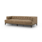A modernized midcentury silhouette meets the traditional Chesterfield sofa, all in a compact profile perfect for smaller spaces. Top-grain leather in a tan hue, button tufting and a smooth touch bring deep comfort to lounging Amethyst Home provides interior design, new home construction design consulting, vintage area rugs, and lighting in the Austin metro area.