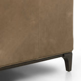 A modernized midcentury silhouette meets the traditional Chesterfield sofa, all in a compact profile perfect for smaller spaces. Top-grain leather in a tan hue, button tufting and a smooth touch bring deep comfort to lounging Amethyst Home provides interior design, new home construction design consulting, vintage area rugs, and lighting in the Los Angeles metro area.