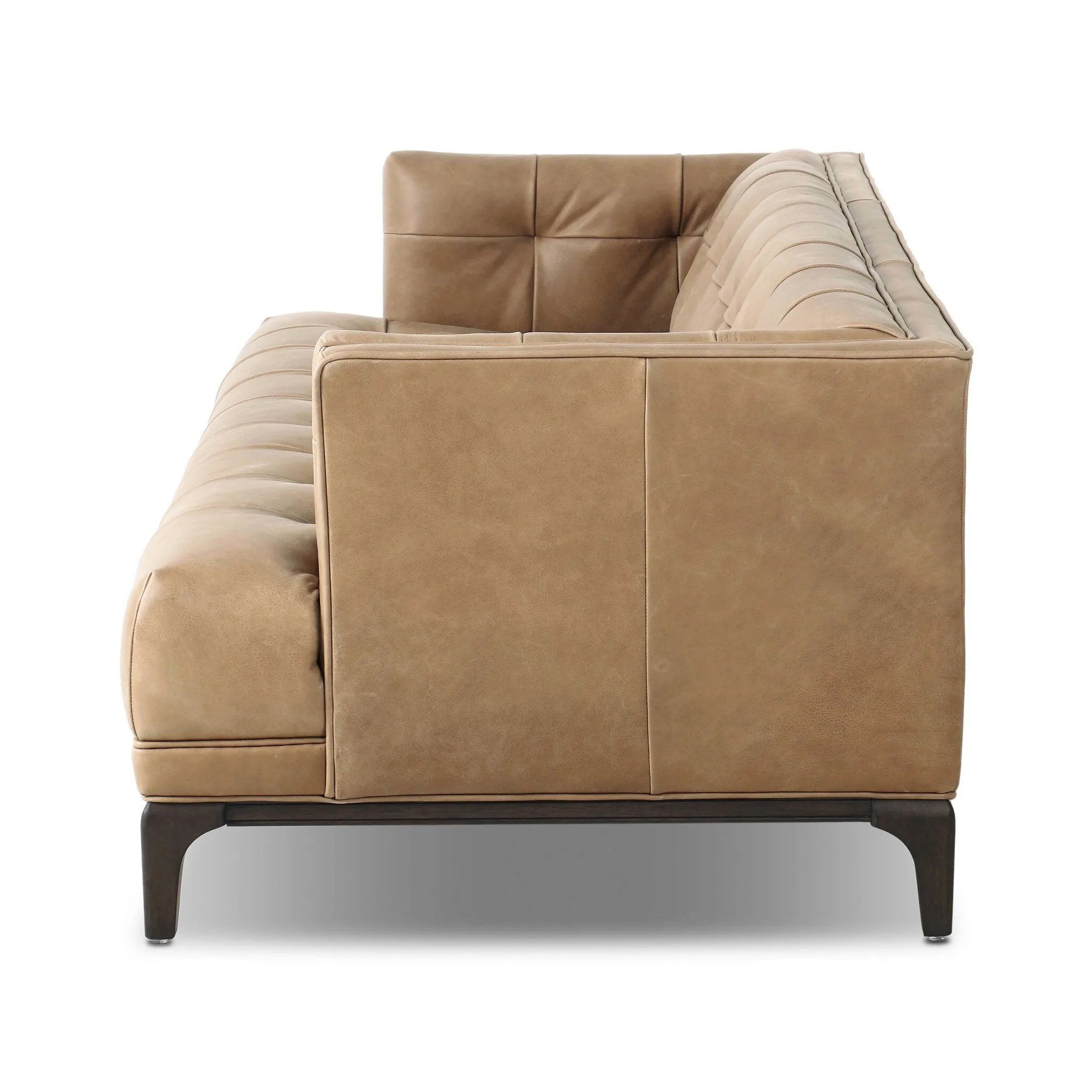 A modernized midcentury silhouette meets the traditional Chesterfield sofa, all in a compact profile perfect for smaller spaces. Top-grain leather in a tan hue, button tufting and a smooth touch bring deep comfort to lounging Amethyst Home provides interior design, new home construction design consulting, vintage area rugs, and lighting in the San Diego metro area.