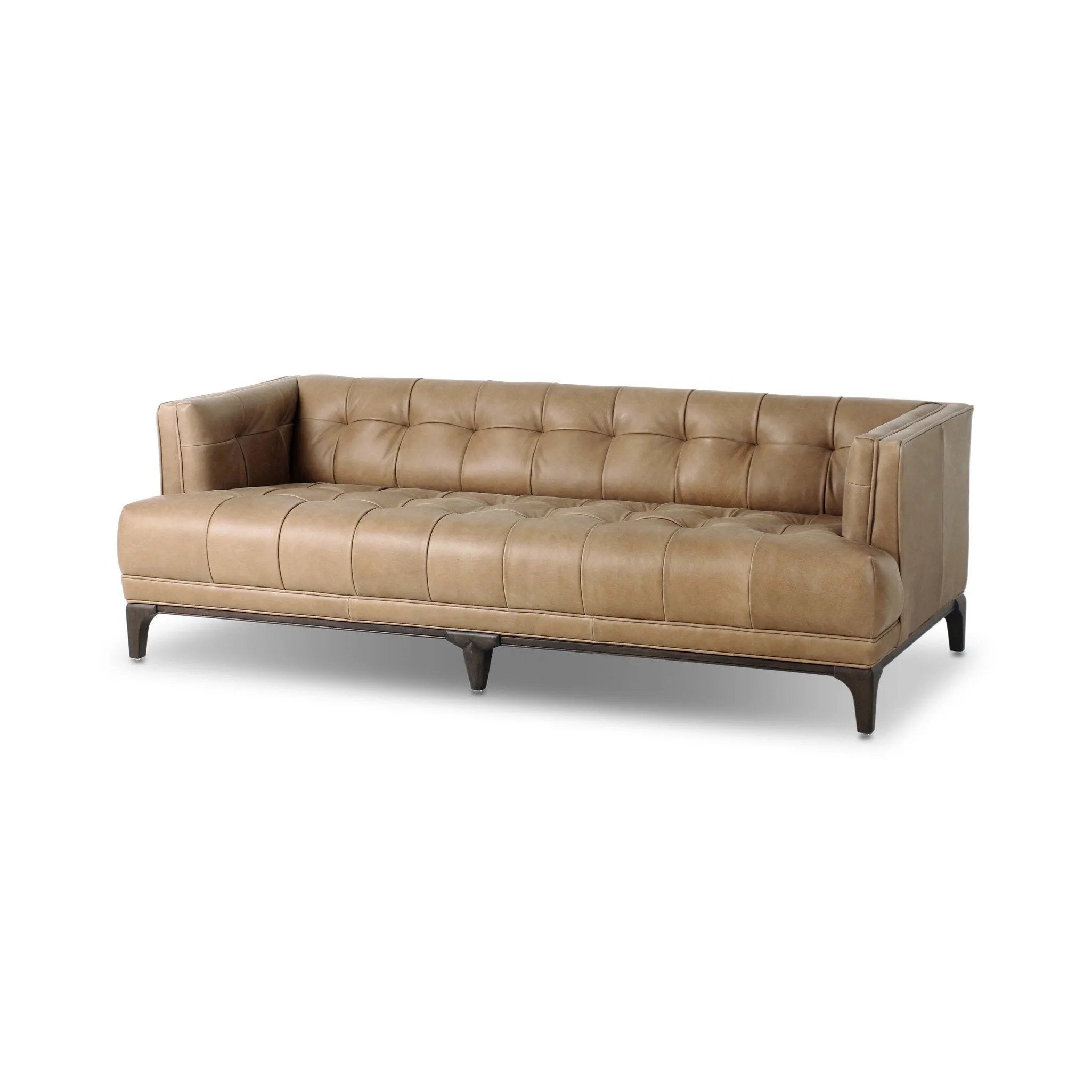 A modernized midcentury silhouette meets the traditional Chesterfield sofa, all in a compact profile perfect for smaller spaces. Top-grain leather in a tan hue, button tufting and a smooth touch bring deep comfort to lounging Amethyst Home provides interior design, new home construction design consulting, vintage area rugs, and lighting in the Washington metro area.