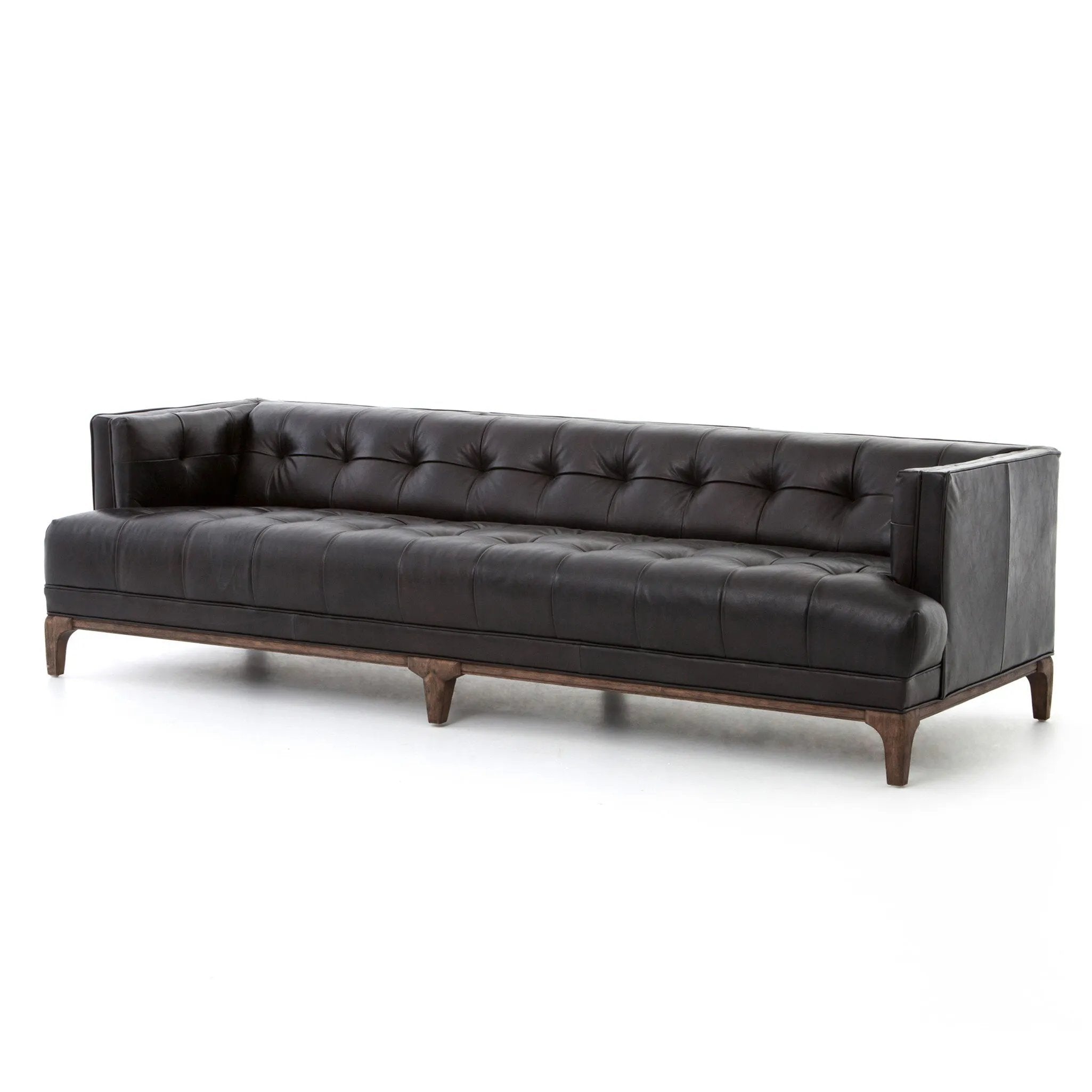 A modernized midcentury silhouette meets the traditional Chesterfield sofa, all in a compact profile perfect for smaller spaces. Top-grain leather in a classic black, button tufting and a smooth touch bring deep comfort to lounging Amethyst Home provides interior design, new home construction design consulting, vintage area rugs, and lighting in the Alpharetta metro area.