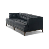 A modernized midcentury silhouette meets the traditional Chesterfield sofa, all in a compact profile perfect for smaller spaces. Top-grain leather in a classic black, button tufting and a smooth touch bring deep comfort to lounging Amethyst Home provides interior design, new home construction design consulting, vintage area rugs, and lighting in the Park City metro area.