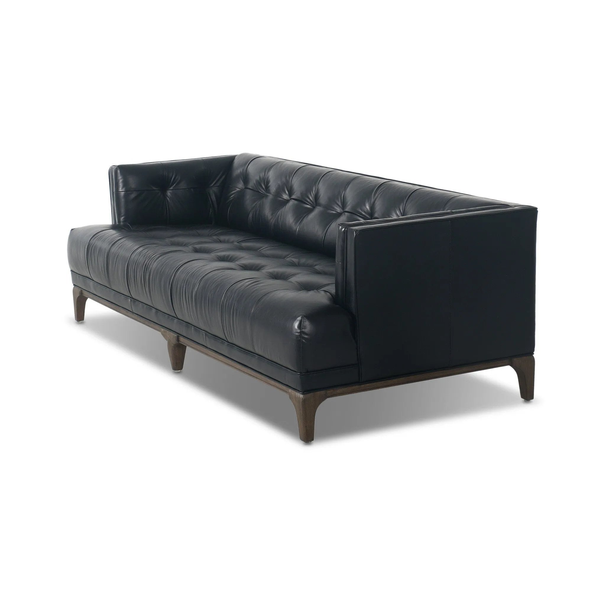 A modernized midcentury silhouette meets the traditional Chesterfield sofa, all in a compact profile perfect for smaller spaces. Top-grain leather in a classic black, button tufting and a smooth touch bring deep comfort to lounging Amethyst Home provides interior design, new home construction design consulting, vintage area rugs, and lighting in the Park City metro area.