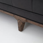 A modernized midcentury silhouette meets the traditional Chesterfield sofa, all in a compact profile perfect for smaller spaces. Top-grain leather in a classic black, button tufting and a smooth touch bring deep comfort to lounging Amethyst Home provides interior design, new home construction design consulting, vintage area rugs, and lighting in the Scottsdale metro area.