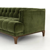 A modernized midcentury silhouette meets the traditional Chesterfield sofa, all in a compact profile perfect for smaller spaces. Smooth velvet in an olive hue, button tufting and a soft touch bring deep comfort to lounging Amethyst Home provides interior design, new home construction design consulting, vintage area rugs, and lighting in the Alpharetta metro area.