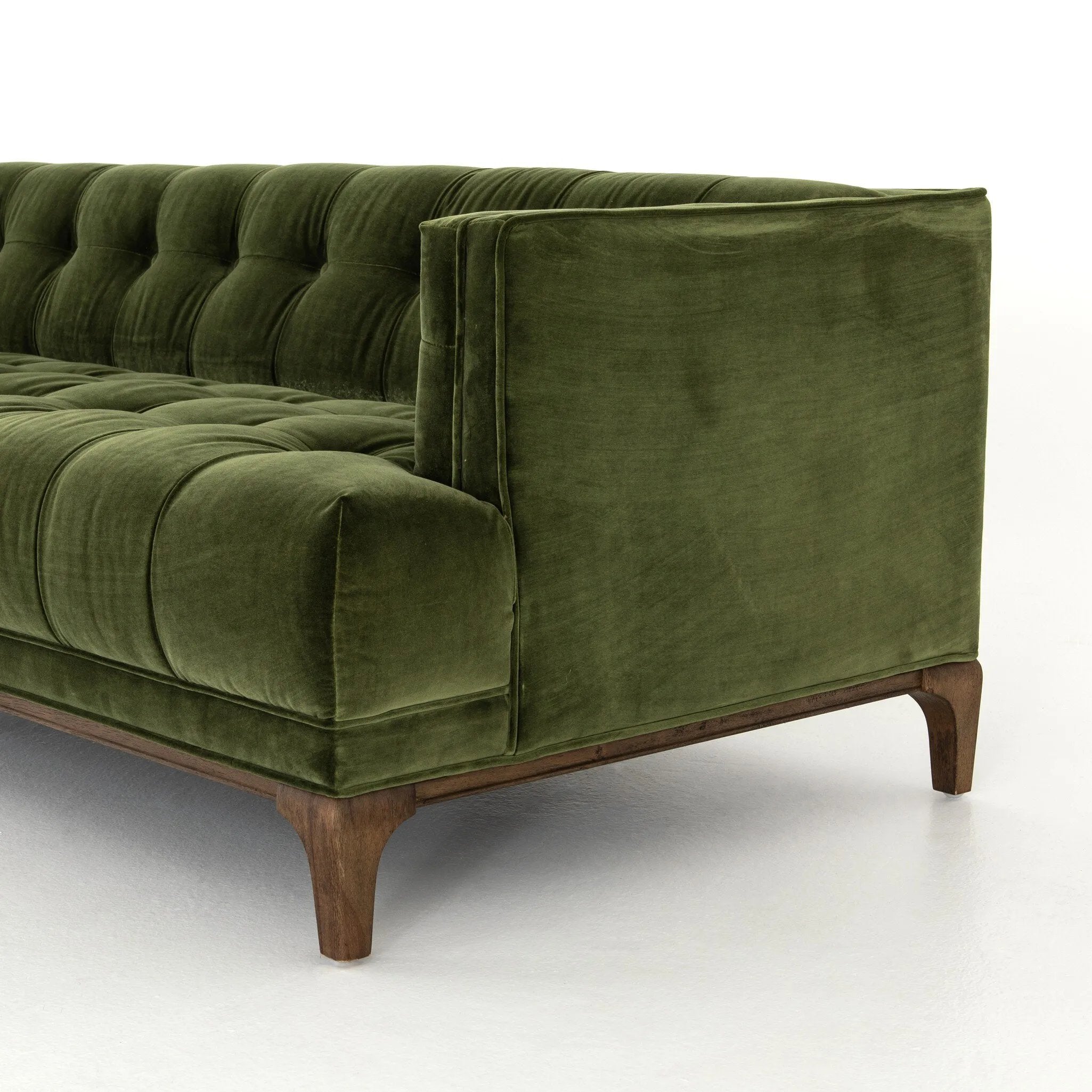 A modernized midcentury silhouette meets the traditional Chesterfield sofa, all in a compact profile perfect for smaller spaces. Smooth velvet in an olive hue, button tufting and a soft touch bring deep comfort to lounging Amethyst Home provides interior design, new home construction design consulting, vintage area rugs, and lighting in the Alpharetta metro area.