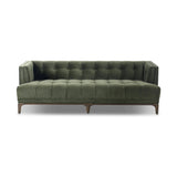 A modernized midcentury silhouette meets the traditional Chesterfield sofa, all in a compact profile perfect for smaller spaces. Smooth velvet in an olive hue, button tufting and a soft touch bring deep comfort to lounging Amethyst Home provides interior design, new home construction design consulting, vintage area rugs, and lighting in the Nashville metro area.