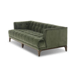 A modernized midcentury silhouette meets the traditional Chesterfield sofa, all in a compact profile perfect for smaller spaces. Smooth velvet in an olive hue, button tufting and a soft touch bring deep comfort to lounging Amethyst Home provides interior design, new home construction design consulting, vintage area rugs, and lighting in the Salt Lake City metro area.
