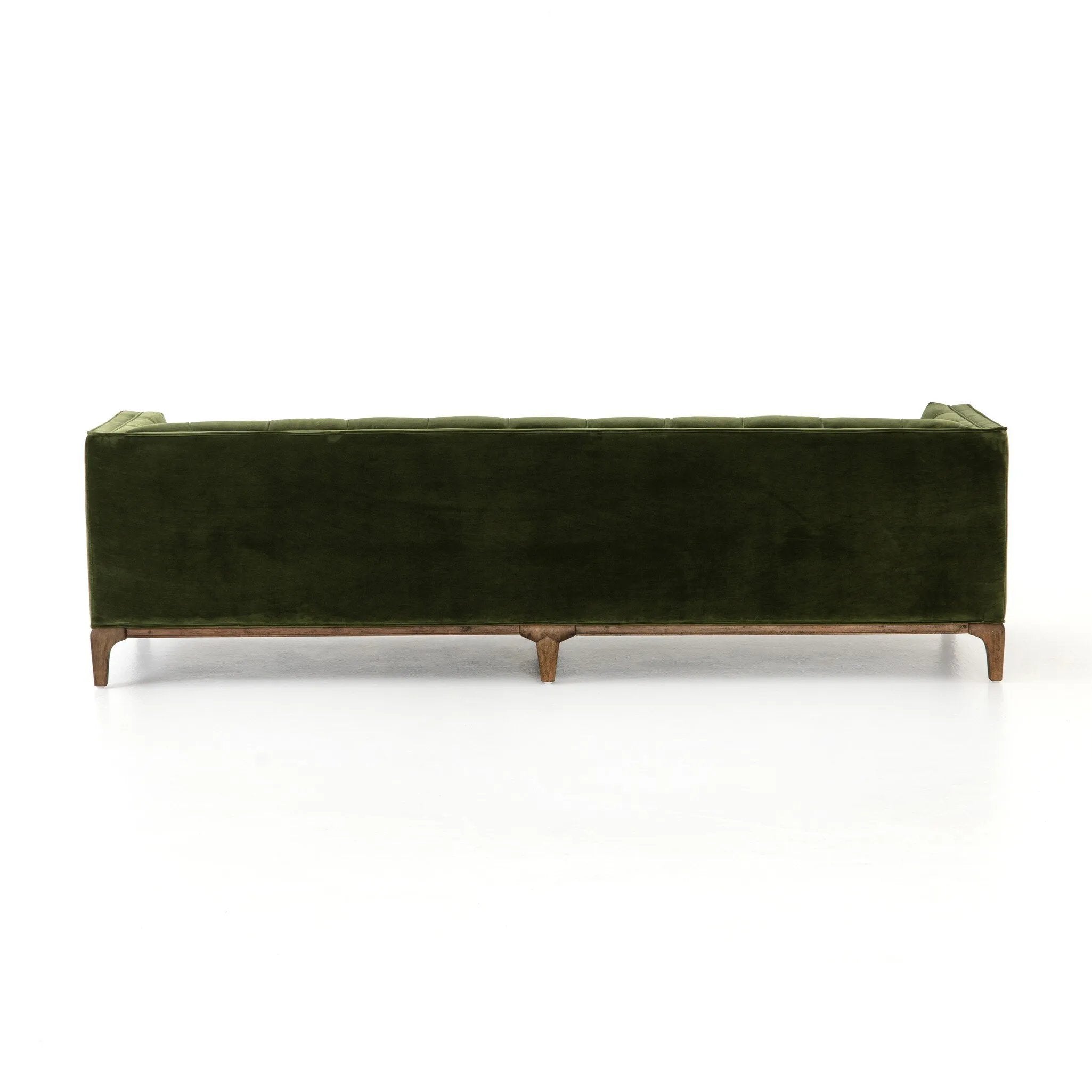 A modernized midcentury silhouette meets the traditional Chesterfield sofa, all in a compact profile perfect for smaller spaces. Smooth velvet in an olive hue, button tufting and a soft touch bring deep comfort to lounging Amethyst Home provides interior design, new home construction design consulting, vintage area rugs, and lighting in the Scottsdale metro area.