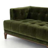A modernized midcentury silhouette meets the traditional Chesterfield sofa, all in a compact profile perfect for smaller spaces. Smooth velvet in an olive hue, button tufting and a soft touch bring deep comfort to lounging Amethyst Home provides interior design, new home construction design consulting, vintage area rugs, and lighting in the Tampa metro area.