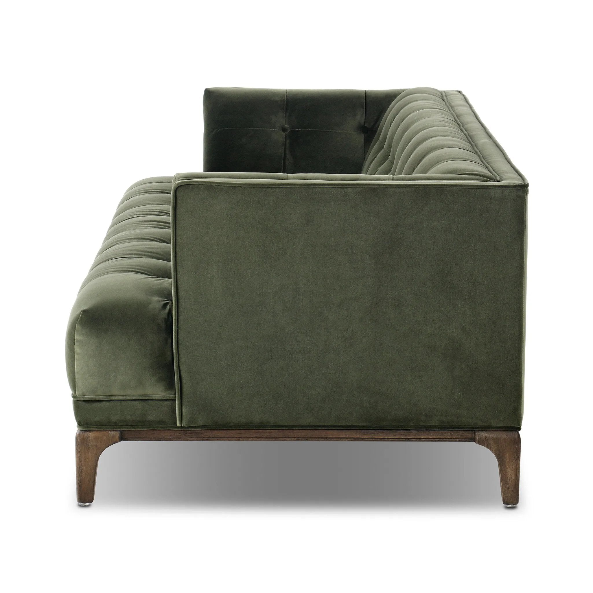 A modernized midcentury silhouette meets the traditional Chesterfield sofa, all in a compact profile perfect for smaller spaces. Smooth velvet in an olive hue, button tufting and a soft touch bring deep comfort to lounging Amethyst Home provides interior design, new home construction design consulting, vintage area rugs, and lighting in the Winter Garden metro area.