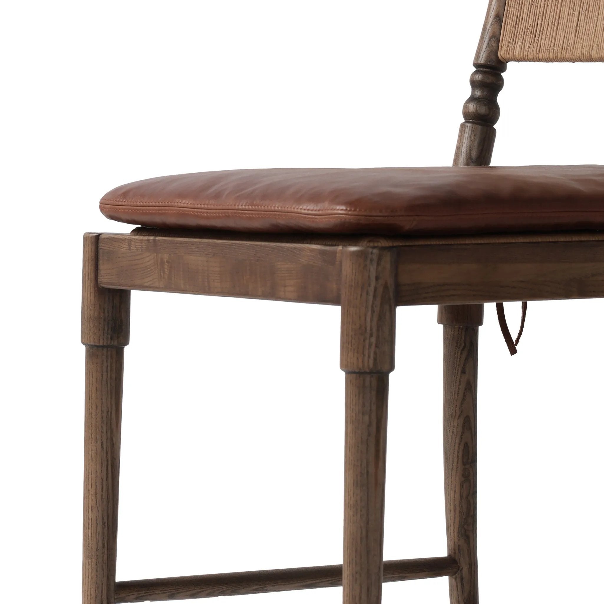 Classic meets current. Simplified turn shaping meets subtly curved legs to elevate a clean, traditional frame of walnut-finished solid ash. A brown top-grain leather cushion complements a back rest of textural paper cord. A design collaboration by Amber Lewis and Four Hands. Amethyst Home provides interior design, new home construction design consulting, vintage area rugs, and lighting in the Los Angeles metro area.
