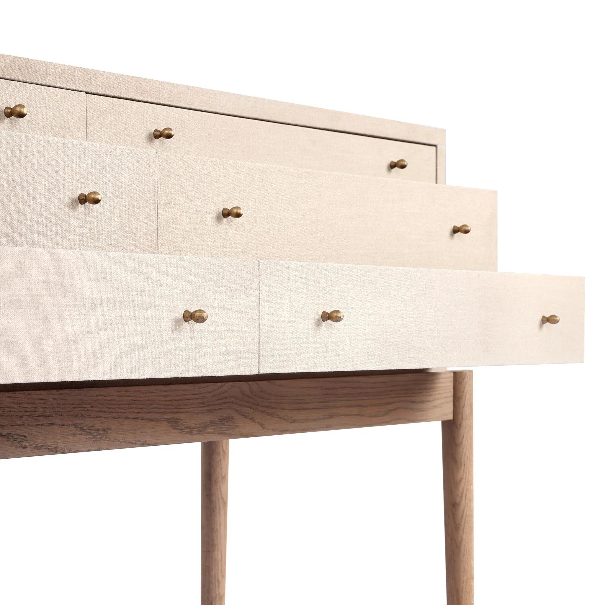A soft statement console table with ample storage, inspired by a dresser silhouette. The elevated case is wrapped in painted linen and sits atop an oak base for a light and airy look Amethyst Home provides interior design, new home construction design consulting, vintage area rugs, and lighting in the Dallas metro area.