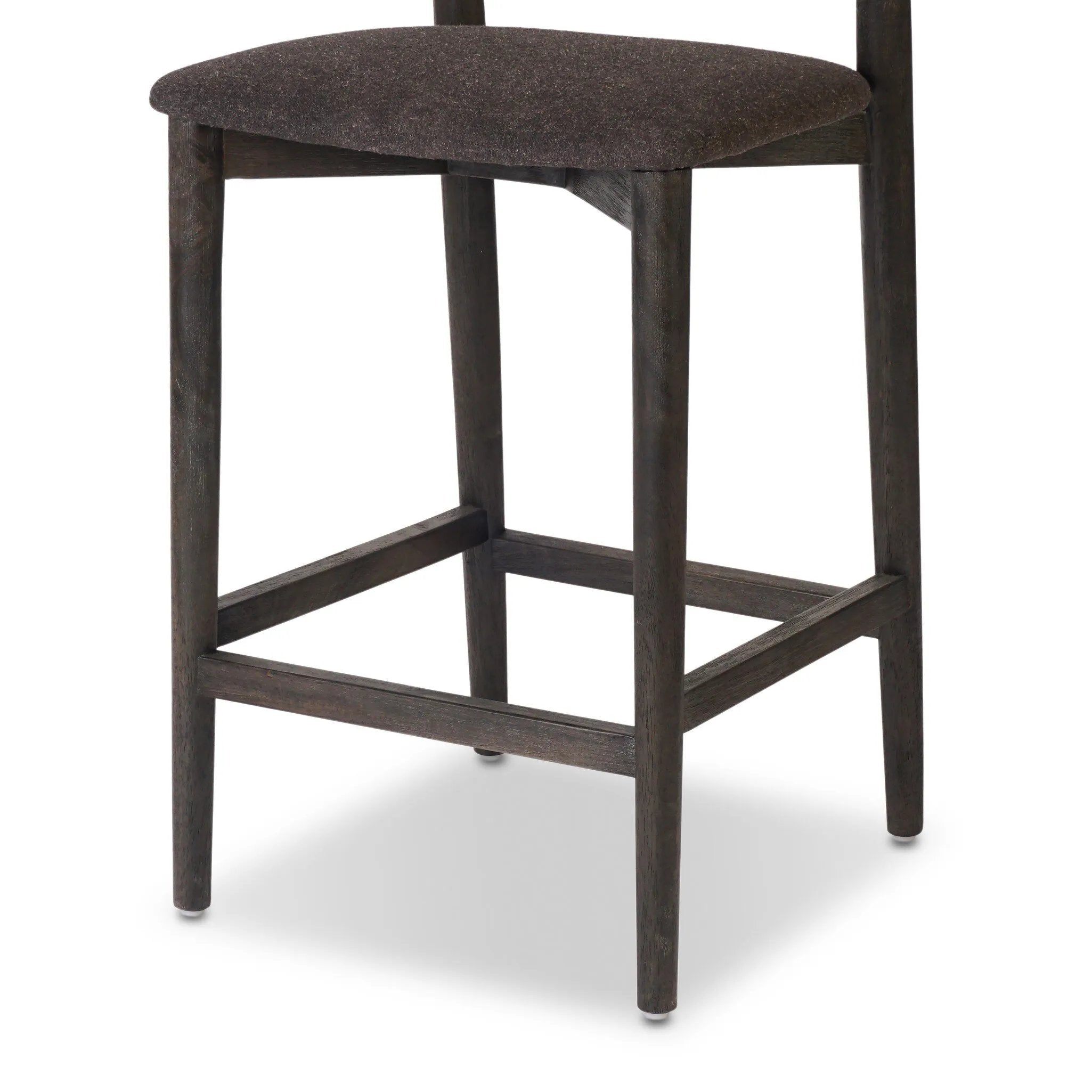 Inspired by simple Scandinavian styling, a dark-finished parawood stool's slit-back metal inlay adds a decorative touch. Easy curves from bent wood give a smooth silhouette. Sized for the counter and upholstered with a thin seat cushion upholstered in black performance fabric, perfect for dining or entertaining. Amethyst Home provides interior design, new home construction design consulting, vintage area rugs, and lighting in the Salt Lake City metro area.