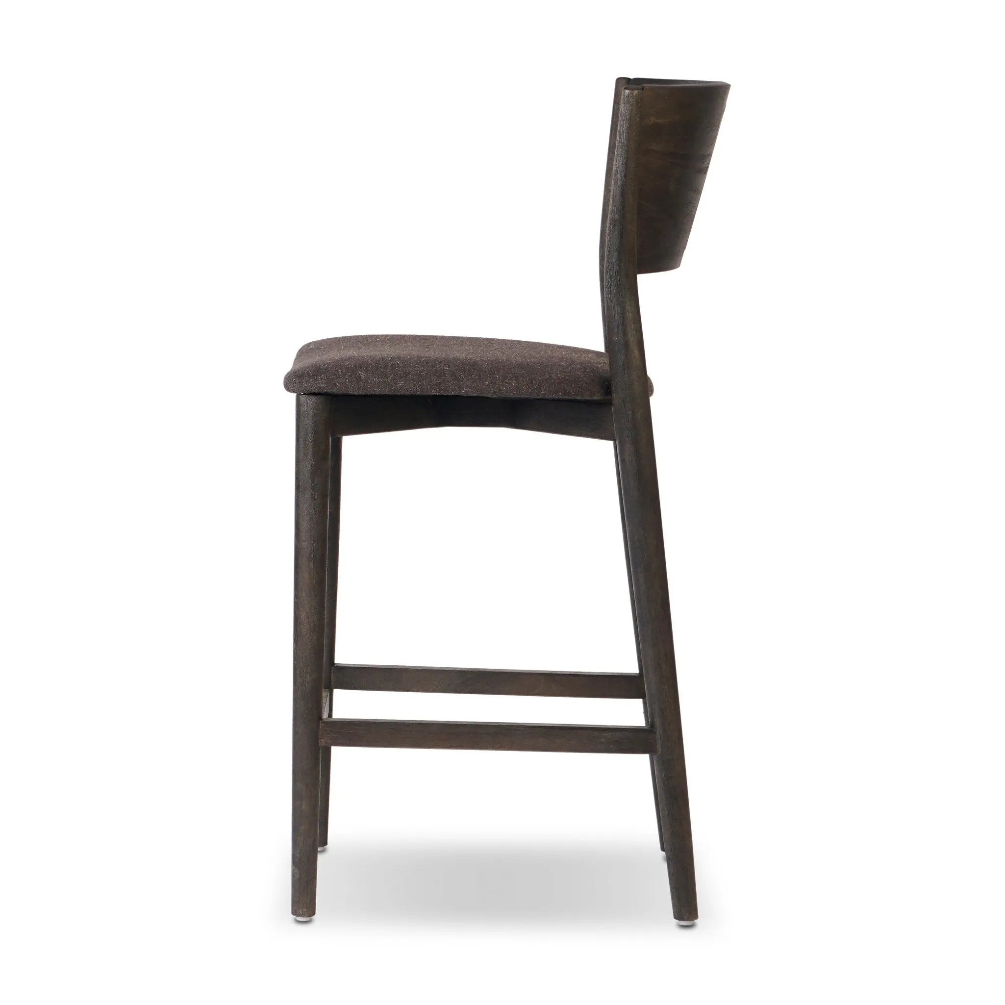Inspired by simple Scandinavian styling, a dark-finished parawood stool's slit-back metal inlay adds a decorative touch. Easy curves from bent wood give a smooth silhouette. Sized for the counter and upholstered with a thin seat cushion upholstered in black performance fabric, perfect for dining or entertaining. Amethyst Home provides interior design, new home construction design consulting, vintage area rugs, and lighting in the Tampa metro area.