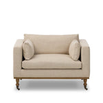 With traditional details like turned oak legs and brass casters, this low-profile accent chair features an elongated bench seat for an inviting sit. Performance fabric in neutral wheat finishes a knife-edge back and boxed arm cushions Amethyst Home provides interior design, new home construction design consulting, vintage area rugs, and lighting in the Alpharetta metro area.